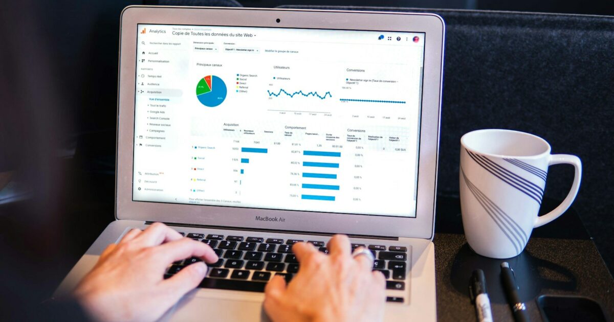 person using macbook pro on black table
