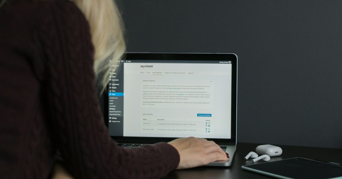 woman in black sweater using macbook pro