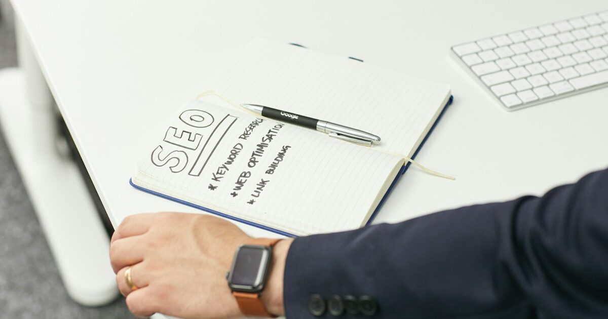 a person writing on a piece of paper