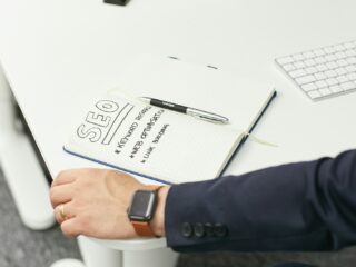 a person writing on a piece of paper